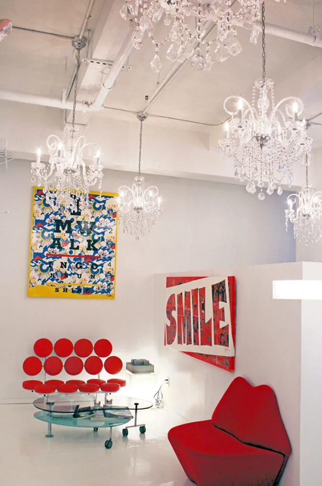 Reception at Cosmetic Dentistry NYC on Park Ave S, with chandeliers and the practice art collection